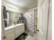 Bathroom featuring a shower with a themed curtain and a single sink with ample counter space at 9329 Dearmont Ave, Orlando, FL 32825