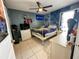 Functional bedroom featuring a ceiling fan, window, and tiled flooring at 9329 Dearmont Ave, Orlando, FL 32825