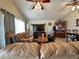 Spacious living room showcasing two couches, a ceiling fan, and a large window for natural light at 9329 Dearmont Ave, Orlando, FL 32825