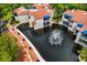 Aerial view of community buildings with red tile roofs, pond, and fountain at 1000 Winderley Pl # 237, Maitland, FL 32751