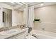 Bathroom with tub, shower, large mirror and single sink vanity at 1000 Winderley Pl # 237, Maitland, FL 32751