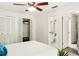 Bedroom with white walls, ceiling fan, closet, and bathroom doorway at 1000 Winderley Pl # 237, Maitland, FL 32751
