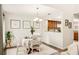 Bright dining room features a round table, white chairs, modern lighting, and kitchen view at 1000 Winderley Pl # 237, Maitland, FL 32751