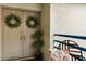 Inviting entryway with double doors, greenery wreaths, a small potted plant, and neutral colors at 1000 Winderley Pl # 237, Maitland, FL 32751