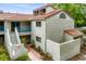 Charming two-story condo features a red tile roof, stucco exterior, and a welcoming blue railing at 1000 Winderley Pl # 237, Maitland, FL 32751