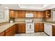 This kitchen features granite countertops, natural wood cabinetry, and stainless-steel appliances at 1000 Winderley Pl # 237, Maitland, FL 32751
