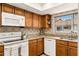 A modern kitchen features granite countertops, stainless steel appliances, and ample cabinet space at 1000 Winderley Pl # 237, Maitland, FL 32751