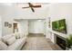 Bright living room with vaulted ceilings, a fireplace, built-in shelving, and neutral decor at 1000 Winderley Pl # 237, Maitland, FL 32751