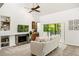 Bright living room with fireplace, built-in shelving, and sliding glass doors to the patio at 1000 Winderley Pl # 237, Maitland, FL 32751