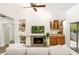 Bright living room showcasing vaulted ceilings, fireplace, cabinets, and sliding glass doors to balcony at 1000 Winderley Pl # 237, Maitland, FL 32751