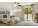 Bright and spacious bedroom with ceiling fan, balcony access, and neutral decor at 1000 Winderley Pl # 237, Maitland, FL 32751