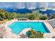 Aerial view of community pool and lounge area overlooking the lake at 1000 Winderley Pl # 237, Maitland, FL 32751