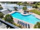 Community pool featuring lounge chairs, sunning deck, and scenic lake views at 1000 Winderley Pl # 237, Maitland, FL 32751