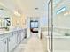 Bathroom features a soaking tub, glass shower, double vanity, mirrors, and decor at 10012 Voyager Way, Orlando, FL 32821