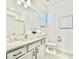 Bright bathroom features a vanity, toilet, sink and mirror at 10012 Voyager Way, Orlando, FL 32821