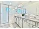 Bathroom featuring double sink vanity and a glass enclosed shower with white tile at 10012 Voyager Way, Orlando, FL 32821