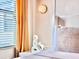 Bright bedroom featuring a light neutral color palette and an accent wall at 10012 Voyager Way, Orlando, FL 32821