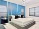 Modern bedroom features stylish blue accent wall and a large bed with neutral linens at 10012 Voyager Way, Orlando, FL 32821