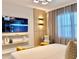 Modern bedroom features a television, accent wall and chair, with soft, natural light from the window at 10012 Voyager Way, Orlando, FL 32821