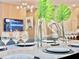 Dining room with a glossy table setting, accompanied by greenery, modern decor, and a cozy atmosphere at 10012 Voyager Way, Orlando, FL 32821