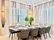 Elegant dining room with a marble table, modern chairs, stylish lighting, and sheer window curtains at 10012 Voyager Way, Orlando, FL 32821