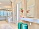 Inviting foyer features tiled floor, stylish decor, a wood-accent wall with a mirror, and comfortable green stools at 10012 Voyager Way, Orlando, FL 32821
