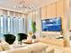 Open living area showcasing a large TV, modern decor, bright lighting, and comfortable seating arrangements at 10012 Voyager Way, Orlando, FL 32821