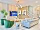 Bright and modern living room with a comfortable gray sofa, green chairs, and a stylish light fixture at 10012 Voyager Way, Orlando, FL 32821