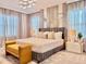 Serene main bedroom featuring a luxurious bed, accent wall, stylish lighting, and elegant curtains at 10012 Voyager Way, Orlando, FL 32821