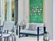 Relaxing patio area with stylish seating, decorative wall art, and serene outdoor ambiance for leisure and entertainment at 10012 Voyager Way, Orlando, FL 32821