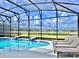 Inviting pool area with lounge chairs, a screened enclosure, and a picturesque view of the community at 10012 Voyager Way, Orlando, FL 32821