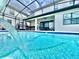 Beautiful pool with a water feature, screened enclosure, and a view of the spacious backyard, ideal for relaxation at 10012 Voyager Way, Orlando, FL 32821