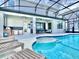 Backyard pool and patio area with lounge chairs, outdoor kitchen, and seamless indoor-outdoor living space at 10012 Voyager Way, Orlando, FL 32821
