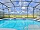 Sparkling pool with a screened enclosure, offering a clear view of the surrounding landscape and neighborhood at 10012 Voyager Way, Orlando, FL 32821