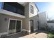 Exterior view of backyard, showcasing sliding door, small patio, and stucco exterior at 1009 Troon Trce, Winter Springs, FL 32708