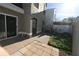 A backyard view with a sliding door, patio, a small garden, and a white fence at 1009 Troon Trce, Winter Springs, FL 32708