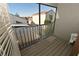 View from the balcony showcasing the neighborhood homes and featuring a wooden floor and metal railing at 1009 Troon Trce, Winter Springs, FL 32708