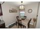 The breakfast nook features tile flooring, a table with four chairs and a hanging light fixture at 1009 Troon Trce, Winter Springs, FL 32708