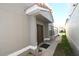 This home's front entry features neutral colored walls and trim, complemented by a charming covered entrance at 1009 Troon Trce, Winter Springs, FL 32708