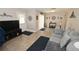 Inviting living room featuring neutral tones, tiled floors, and comfortable gray sofa, perfect for relaxing and entertaining at 1009 Troon Trce, Winter Springs, FL 32708