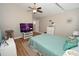 Bright bedroom with ceiling fan, wood floors, and a calming aqua decor, provides a relaxing space at 1009 Troon Trce, Winter Springs, FL 32708