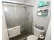 Modern shower with glass doors, marble-look walls, and pebble floor, combining style with functionality at 1009 Troon Trce, Winter Springs, FL 32708