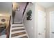 Bright staircase with wood treads, white risers, and decorative 'HOME' sign, adding a cozy touch at 1009 Troon Trce, Winter Springs, FL 32708