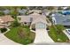 Aerial view of the home, highlighting its well-manicured lawn, landscaping, and two-car garage at 1071 Sweet Tree Ct, Apopka, FL 32712