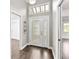 Bright entryway featuring wood flooring and a decorative glass front door and sidelights at 1071 Sweet Tree Ct, Apopka, FL 32712