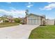 Exterior view of the home featuring a spacious driveway and attached two-car garage at 1071 Sweet Tree Ct, Apopka, FL 32712