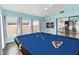 Bright game room with blue pool table, ample natural light, and views of the home's interior at 1071 Sweet Tree Ct, Apopka, FL 32712