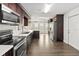 Large kitchen featuring stainless steel appliances, granite countertops, dark wood cabinets and abundant storage space at 1071 Sweet Tree Ct, Apopka, FL 32712