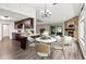 Spacious open layout featuring dark wood cabinetry, stainless steel appliances, and modern dining set at 1071 Sweet Tree Ct, Apopka, FL 32712