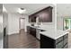 A clean, well-lit kitchen featuring dark wood cabinetry, stainless steel appliances and a bright white countertop at 1071 Sweet Tree Ct, Apopka, FL 32712